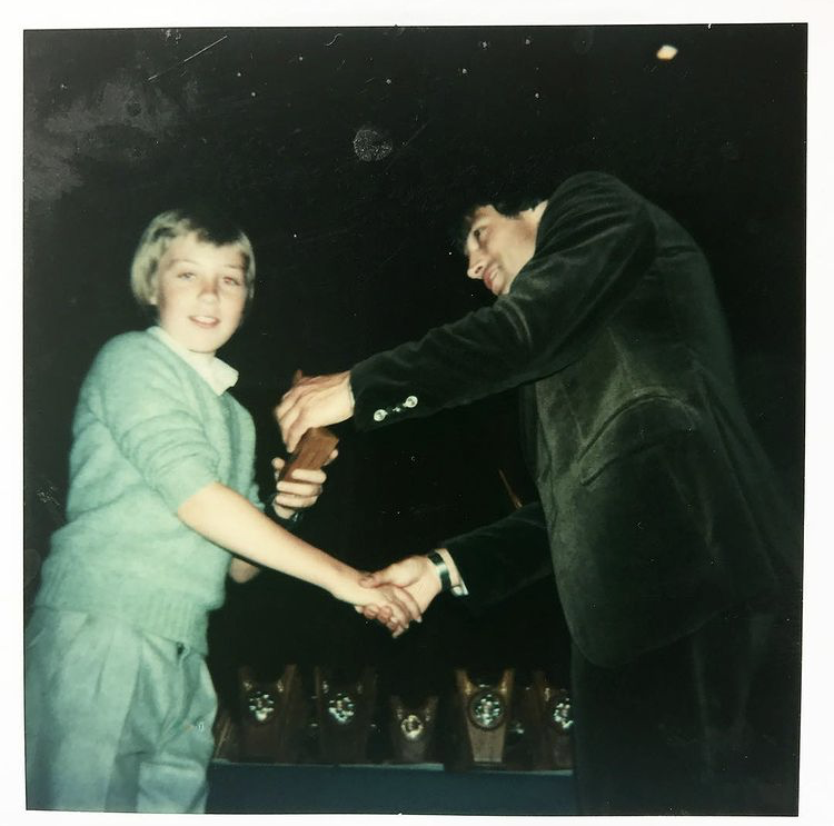 Gary as a child shaking hands with Dario Gradi